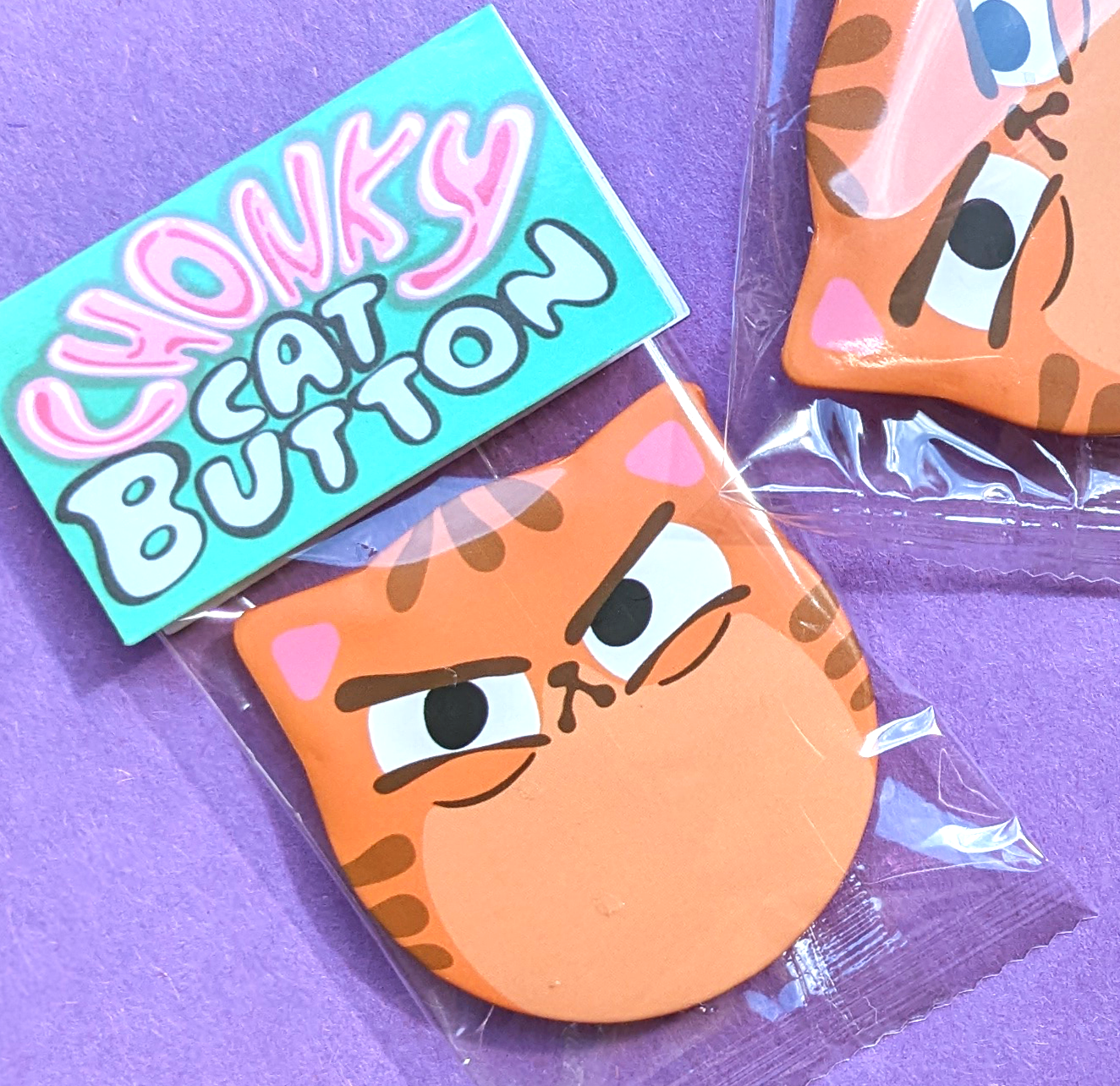 Judgy Orange tabby cat ear button in cute packaging. Makes a great gift for a cat mom or cat dad!