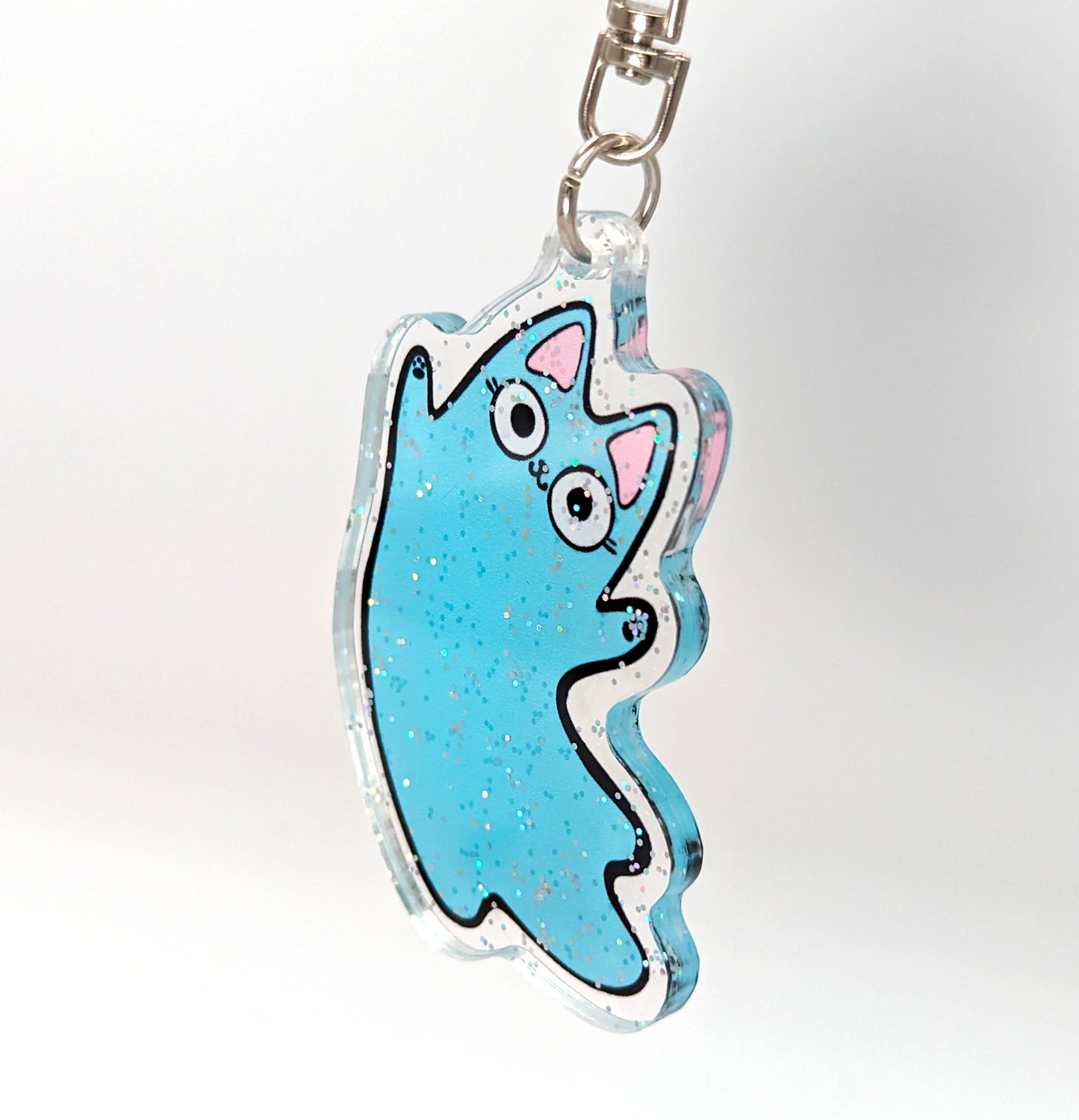 Zoom in of acrylic blue ghost cat keychain with glitter