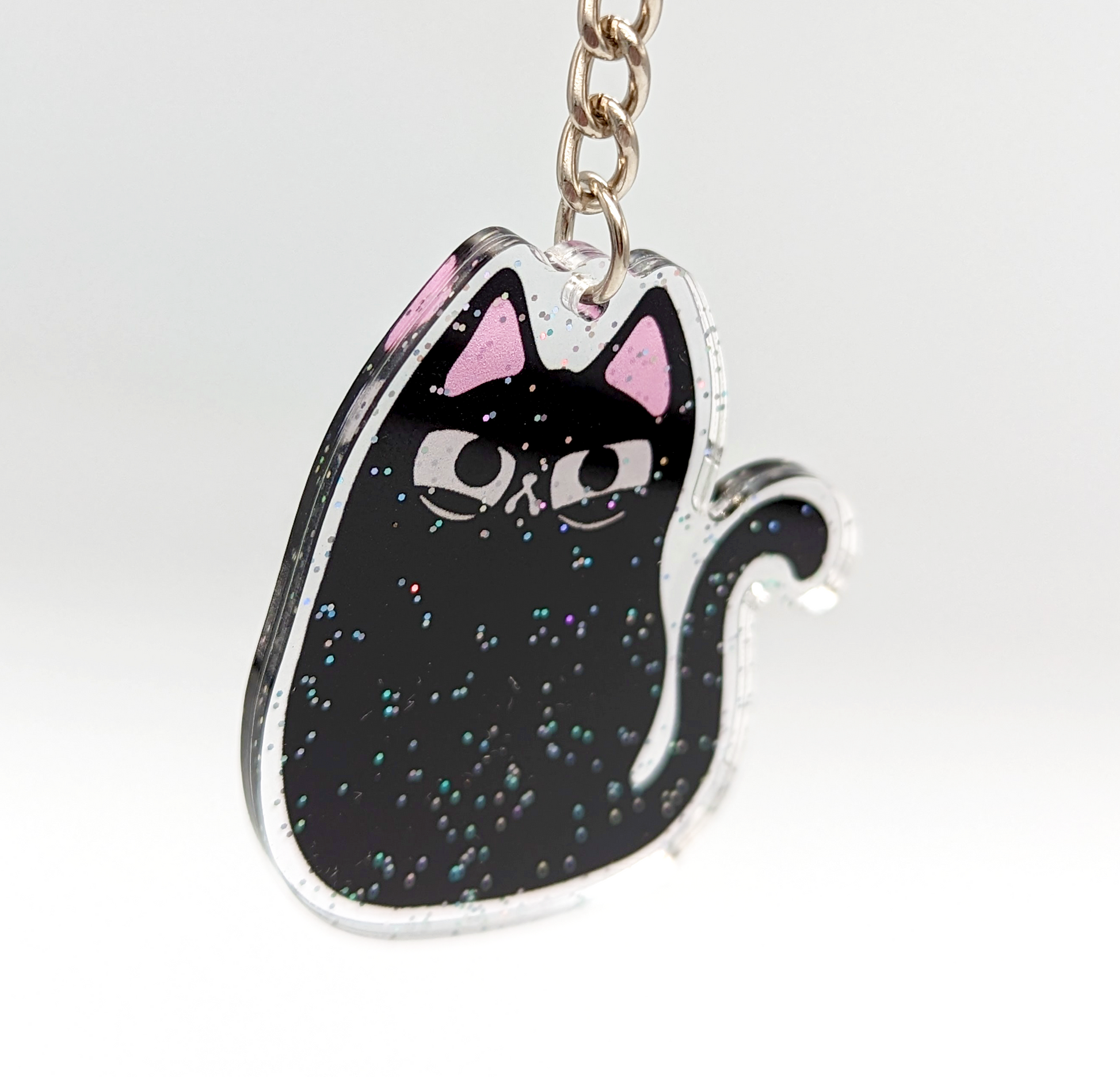 Kawaii fashion cat keychain. A cute black cat keychain dangles.