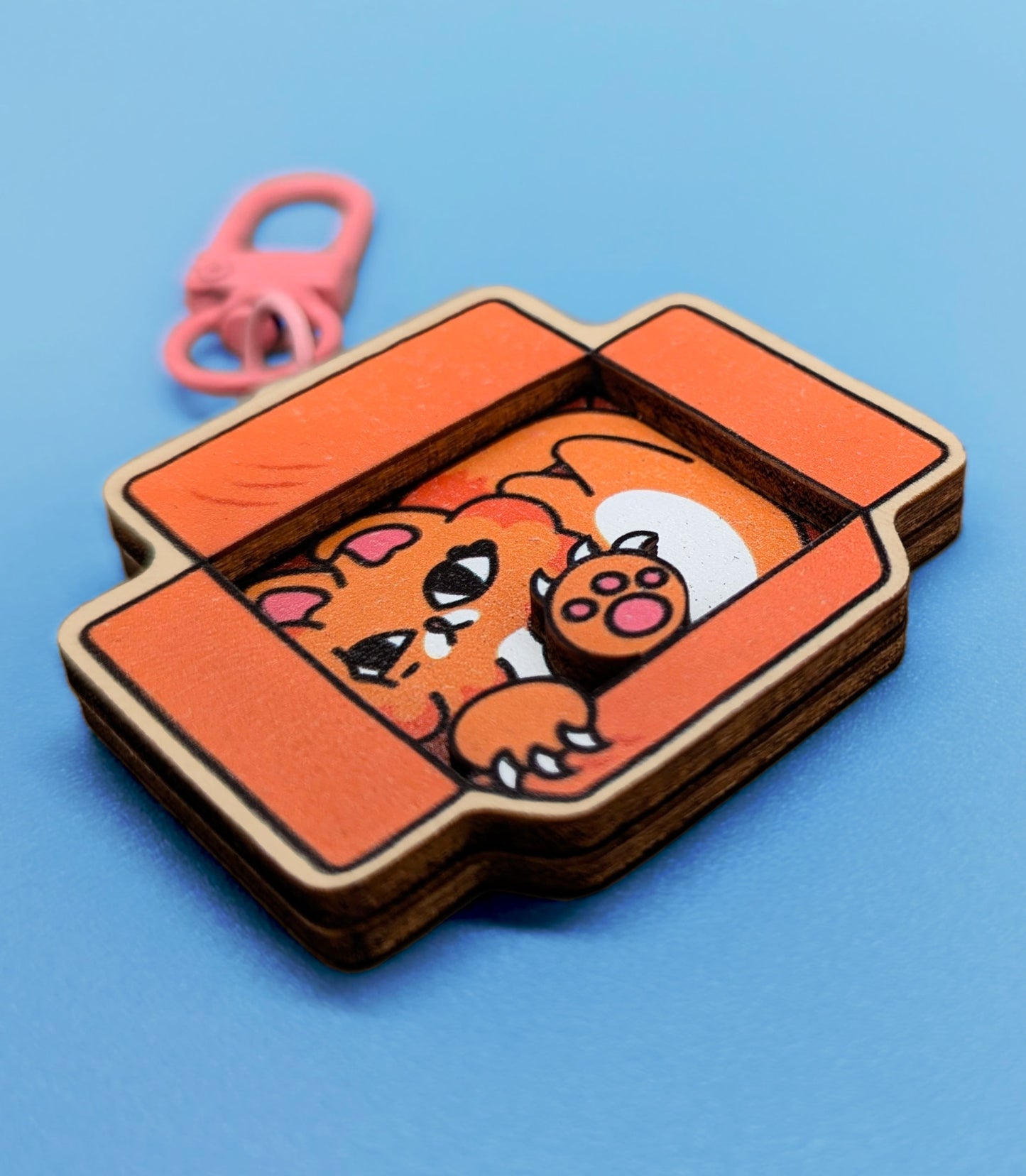 Wooden toy with cartoon cat design on a blue background