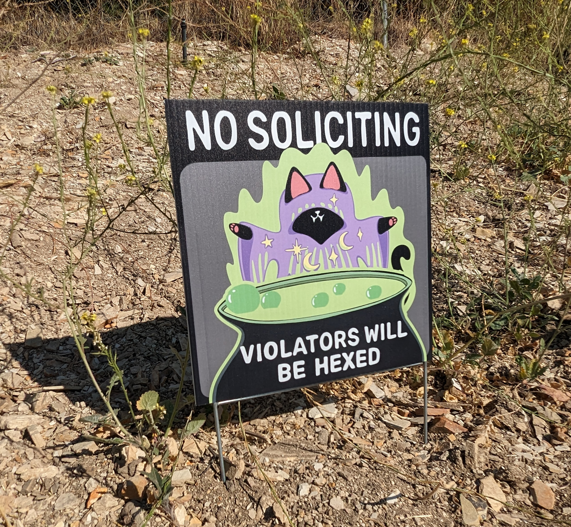 witch cat no soliciting sign with are of cat by a cauldron