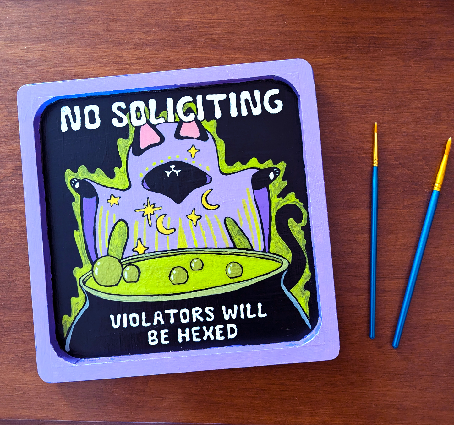 Hand Painted No Soliciting Witch Cat Sign (Violators Will Be Hexed)Acrylic paint carefully painted onto a wood sign then sealed with a layer of mod podge to protect against outdoor weather. There will be very slight variations between each piece since they're all hand painted.