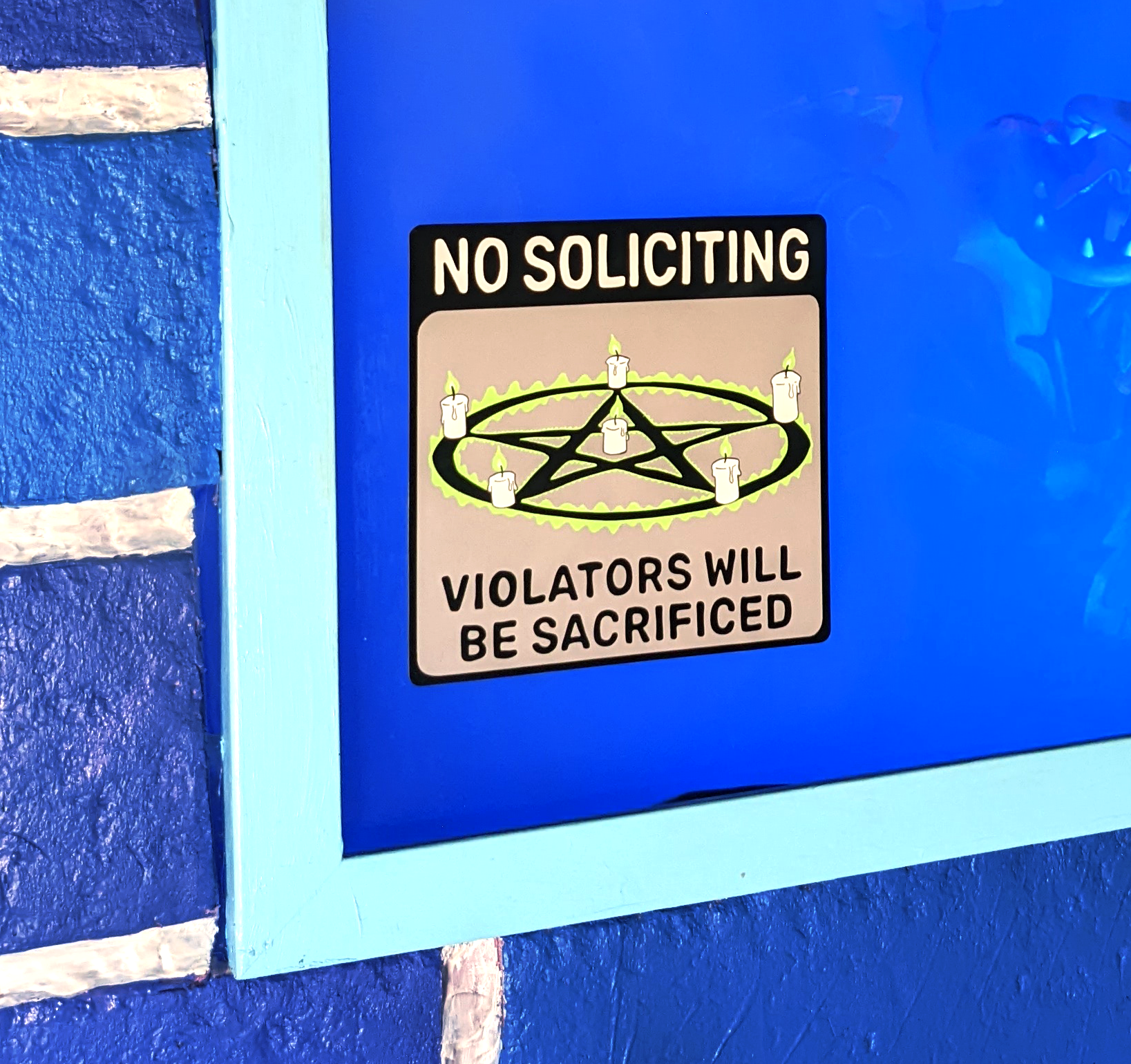 close up of No Soliciting Sign static cling with Pentagram that reads Violators Will Be Sacrificed