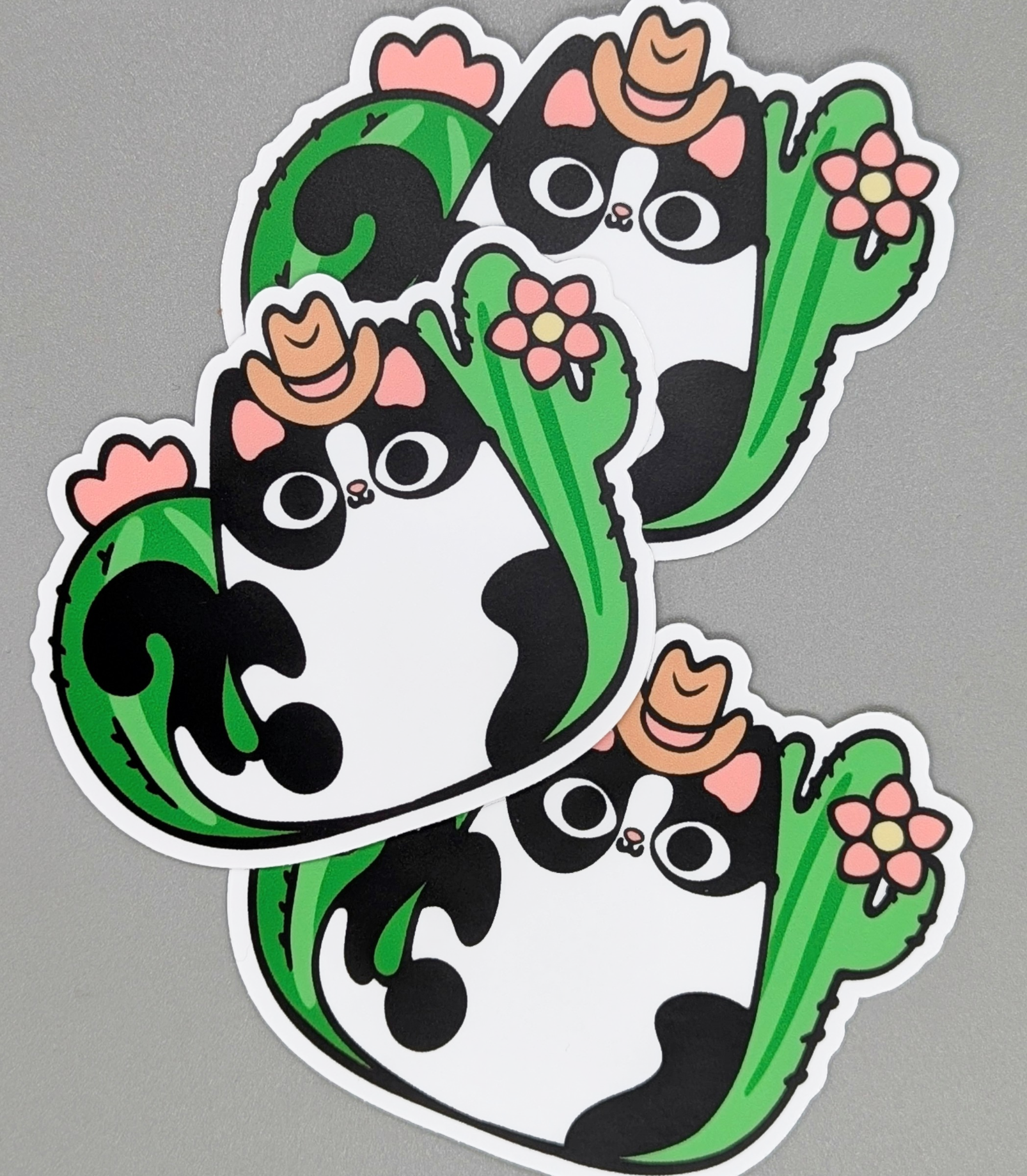 Sticker of a cat with cactus design on a gray background
