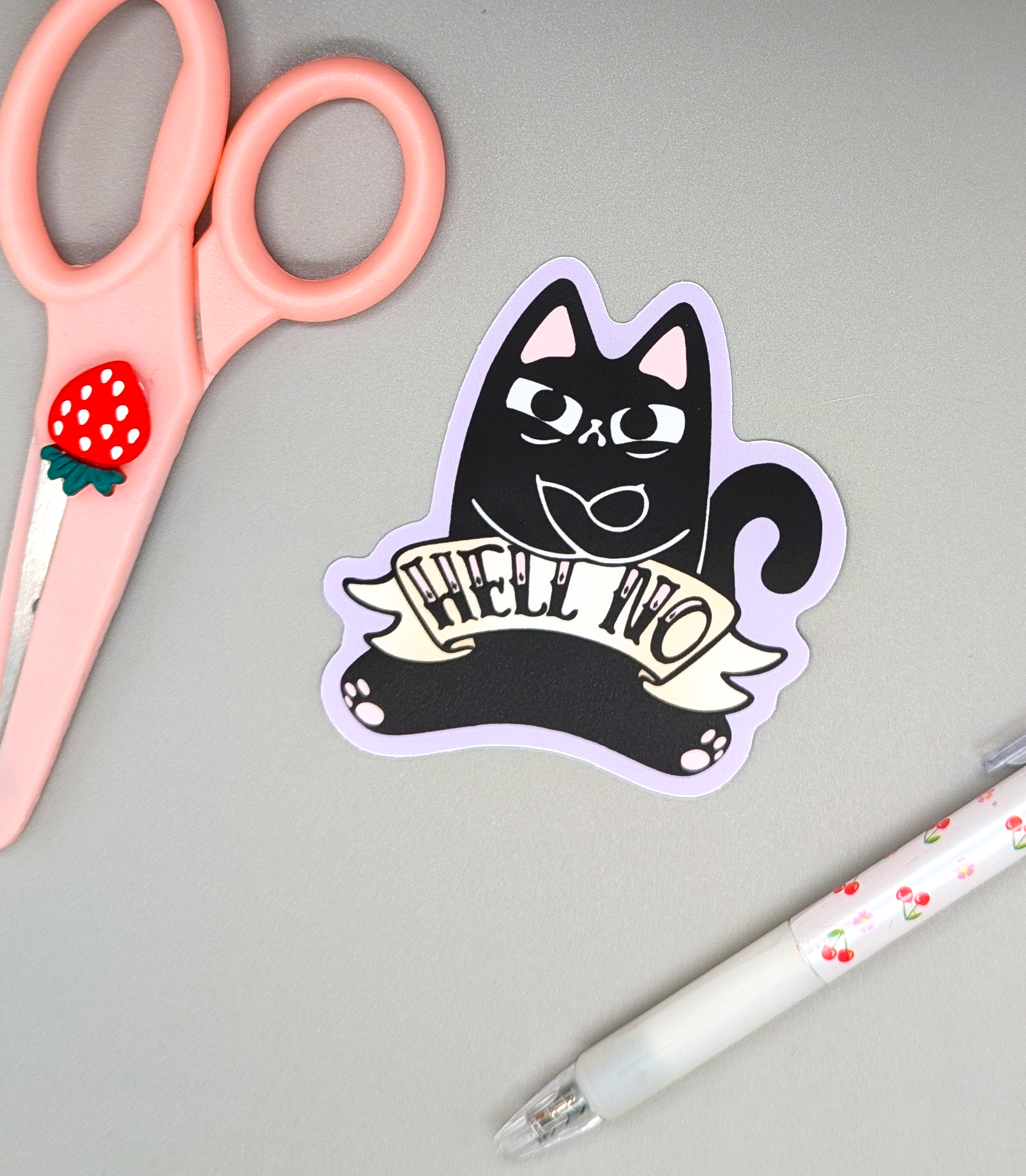 Shows sticker of black cat in a stubborn angry way