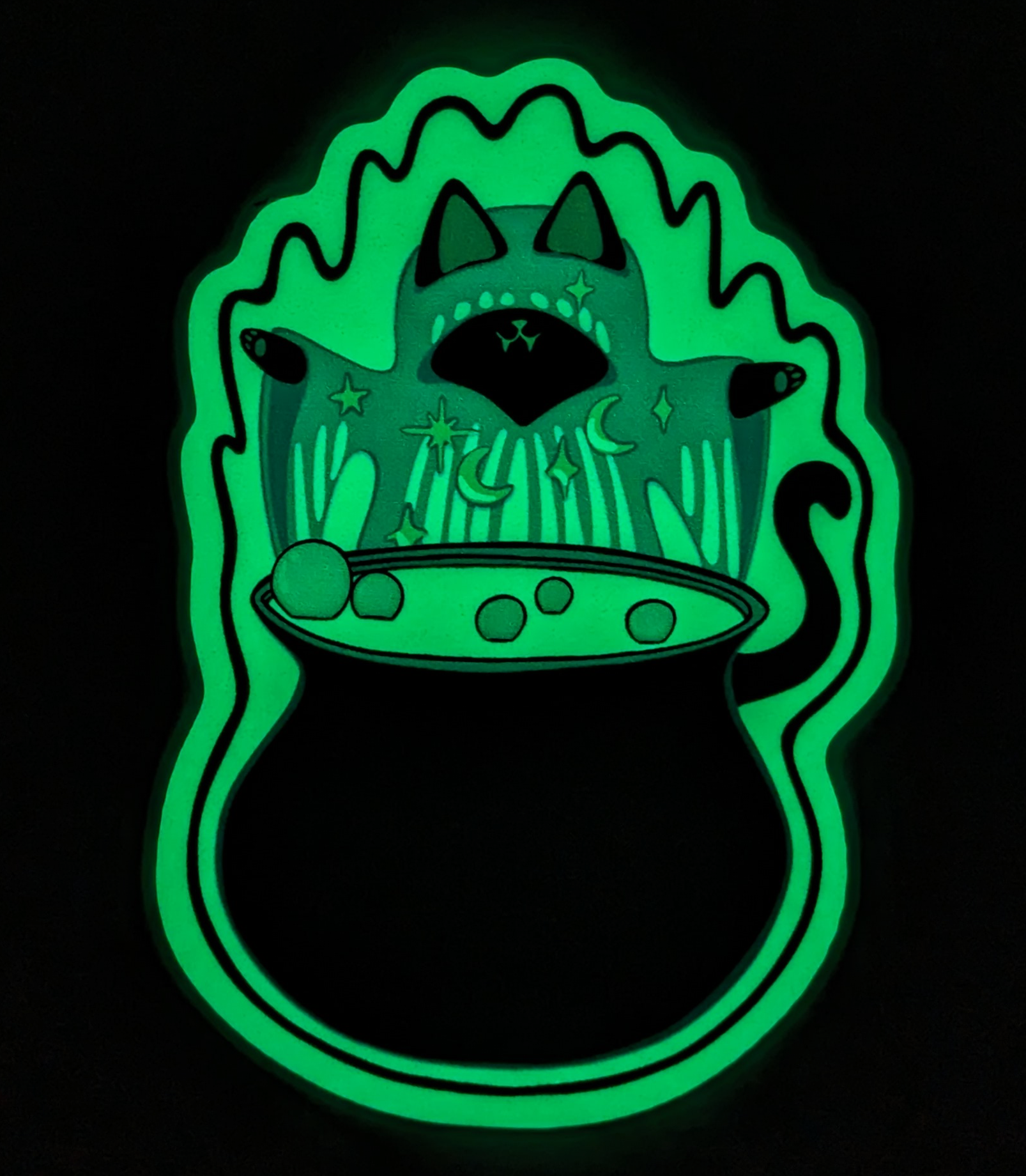 Glow in the Dark Holo Witch Cat Vinyl Waterproof Diecut Sticker is glowing in the dark