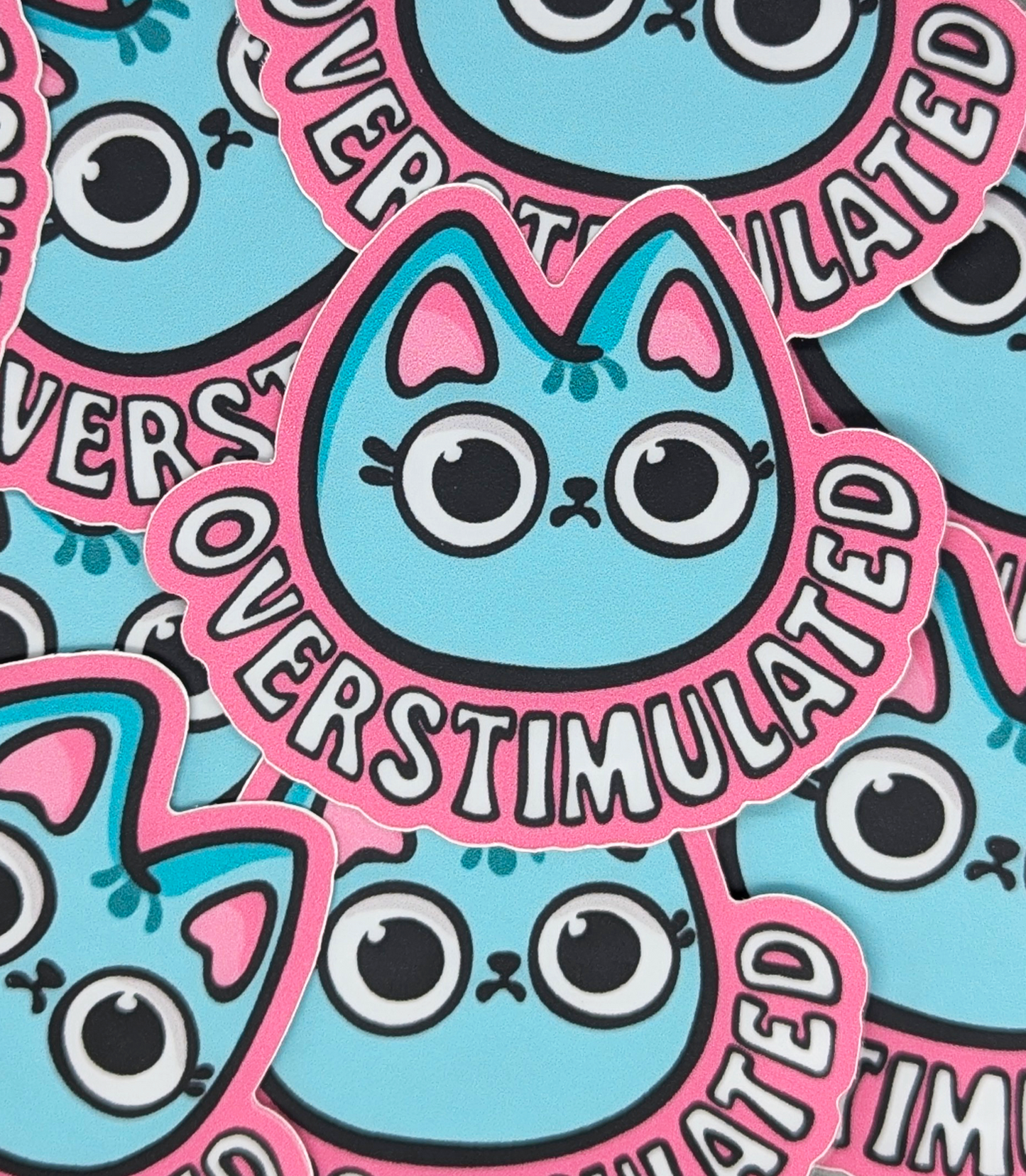 Overstimulated Wide Eyed Cat Sticker Heavy Duty Vinyl 3" picture shows several stickers stacked on top of each other