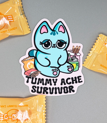 Kawaii Blue Cat is surround by snacks such as chocolate bar, lemon soda, pocky and spicy chips.Cute little cat has a stomach ache after eating yummy snacks! Tummy Ache Survivor Cat Sticker Heavy Duty Vinyl 3"