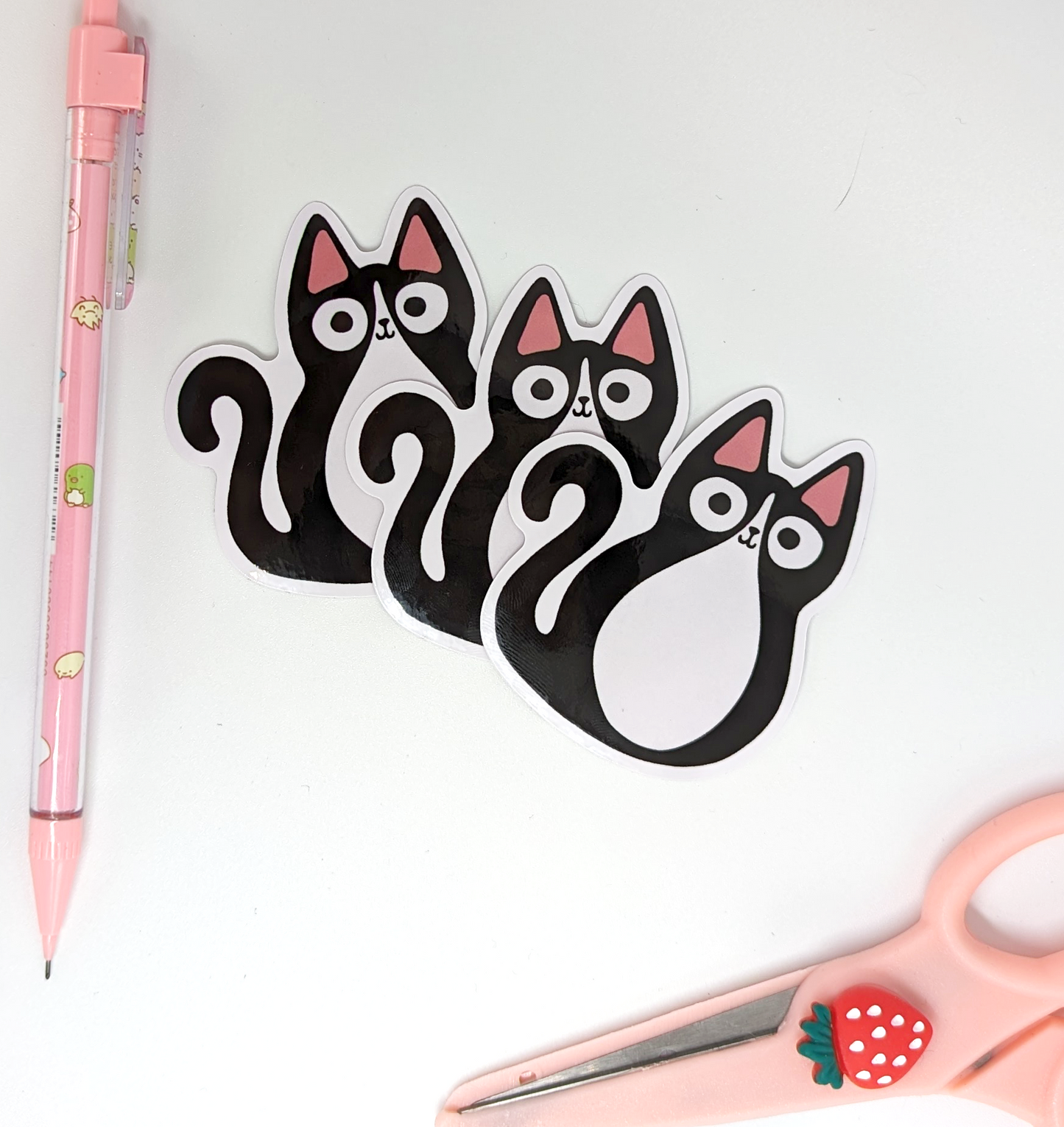 close up of Tuxedo cat Stickers that have a gloss finish and are waterproof