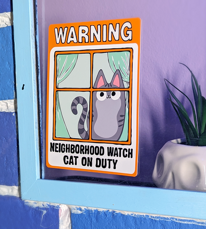 Gray Tabby Indoor Cat in Neighborhood Watch Cat Window Cling displayed on window of home