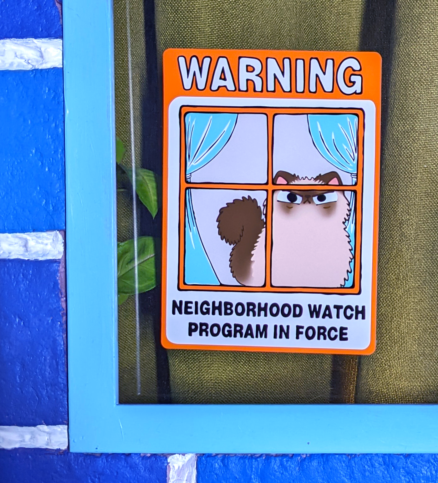 Close up of a Neighborhood Watch Cat Window Cling of Himalayan Cat displayed on a house window