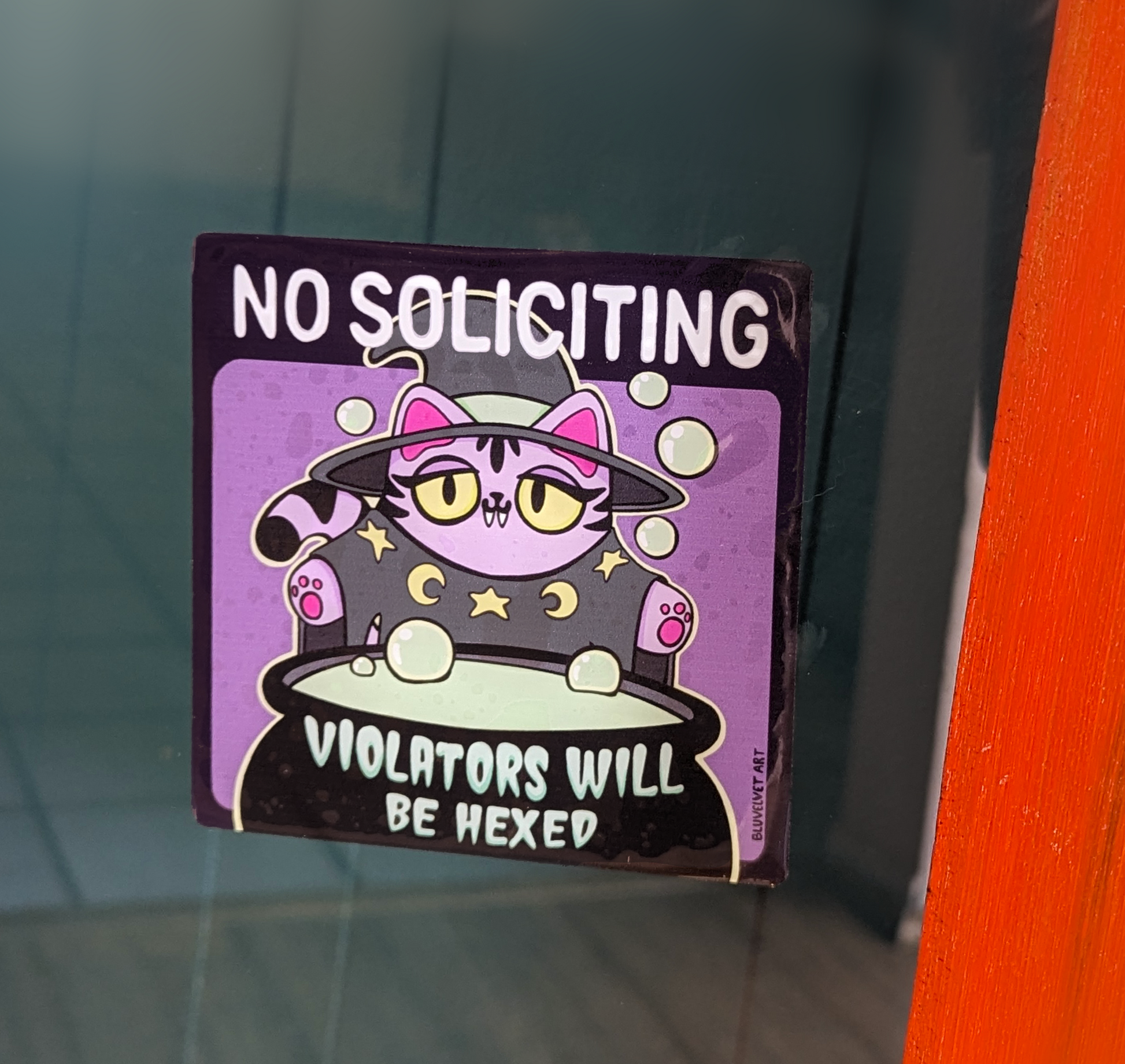 No Soliciting Violators Will Be Hexed Violet Cat Window Cling displayed on a window for solicitors to see