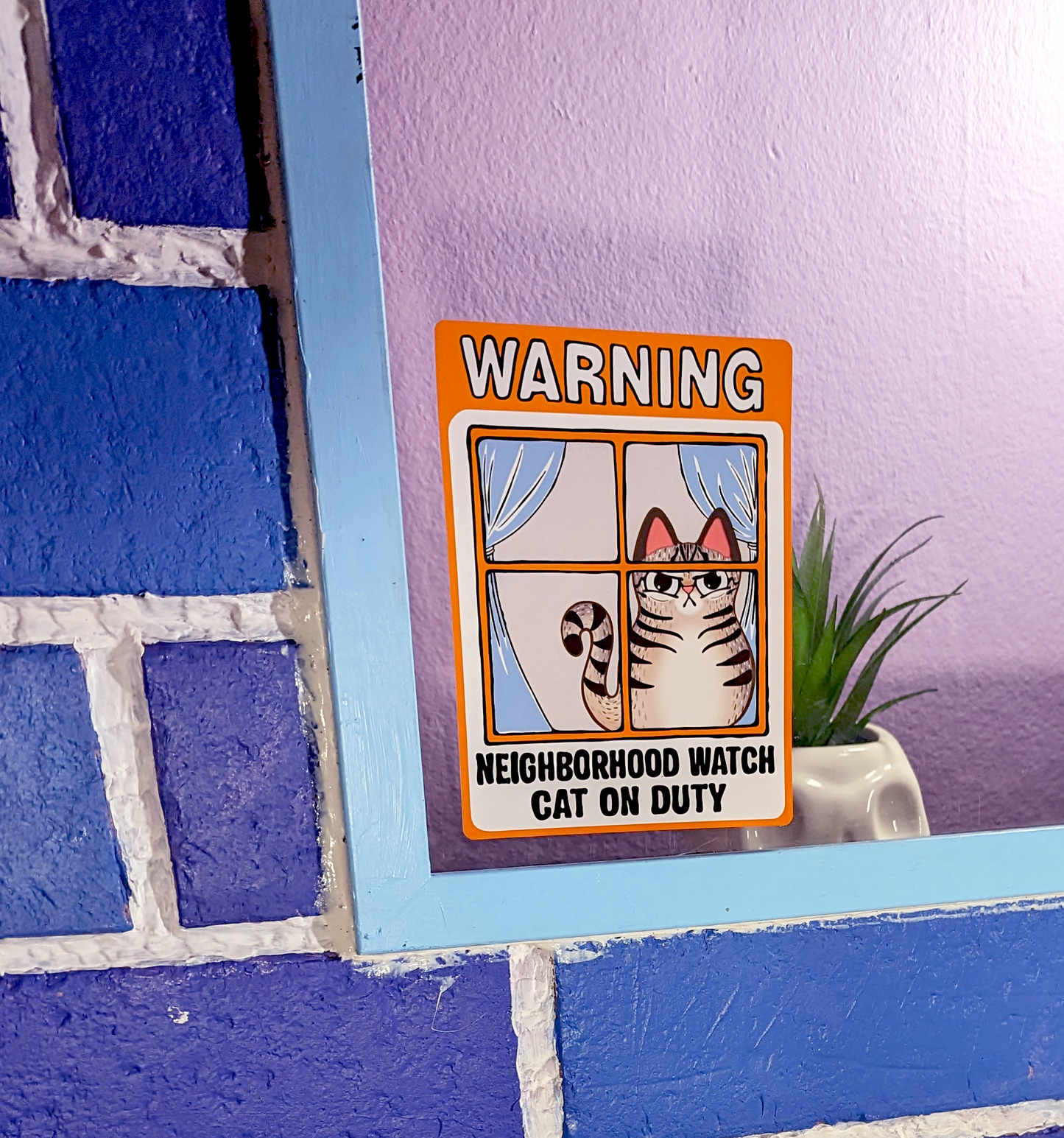 silly cat pun window cling of an angry tabby cat that reads neighborhood watch cat on duty