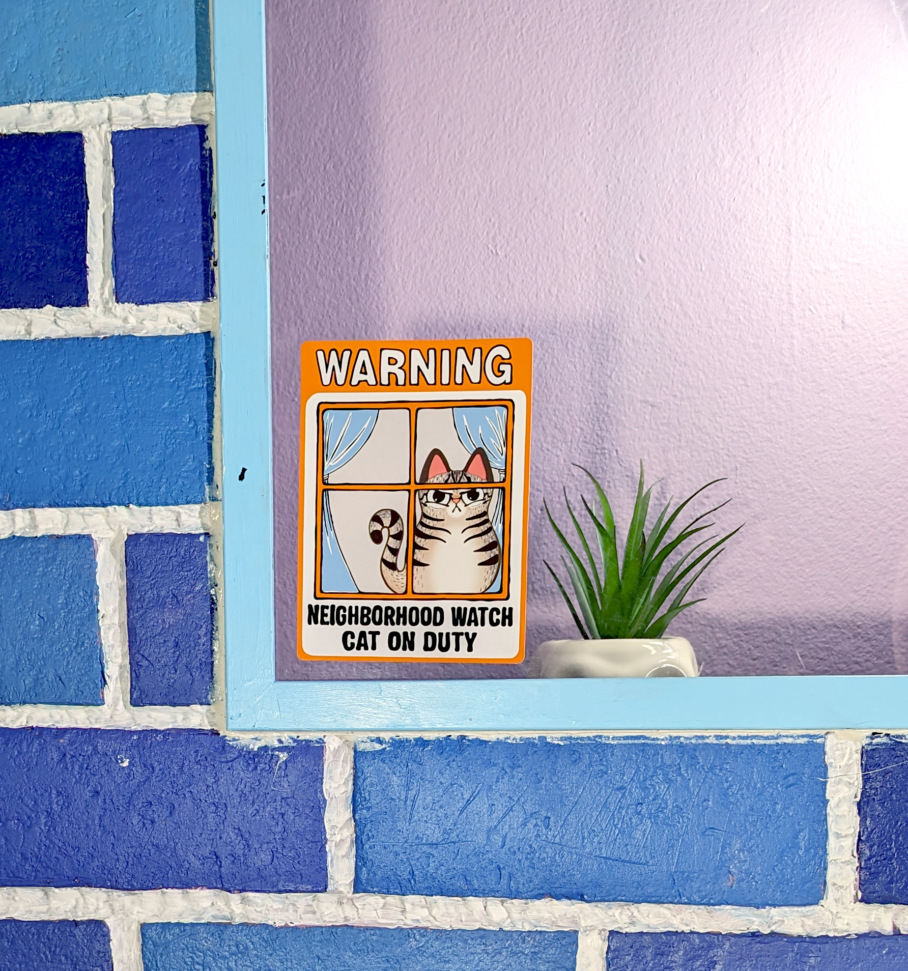 silly cat pun window cling of an angry tabby cat that reads neighborhood watch cat on duty