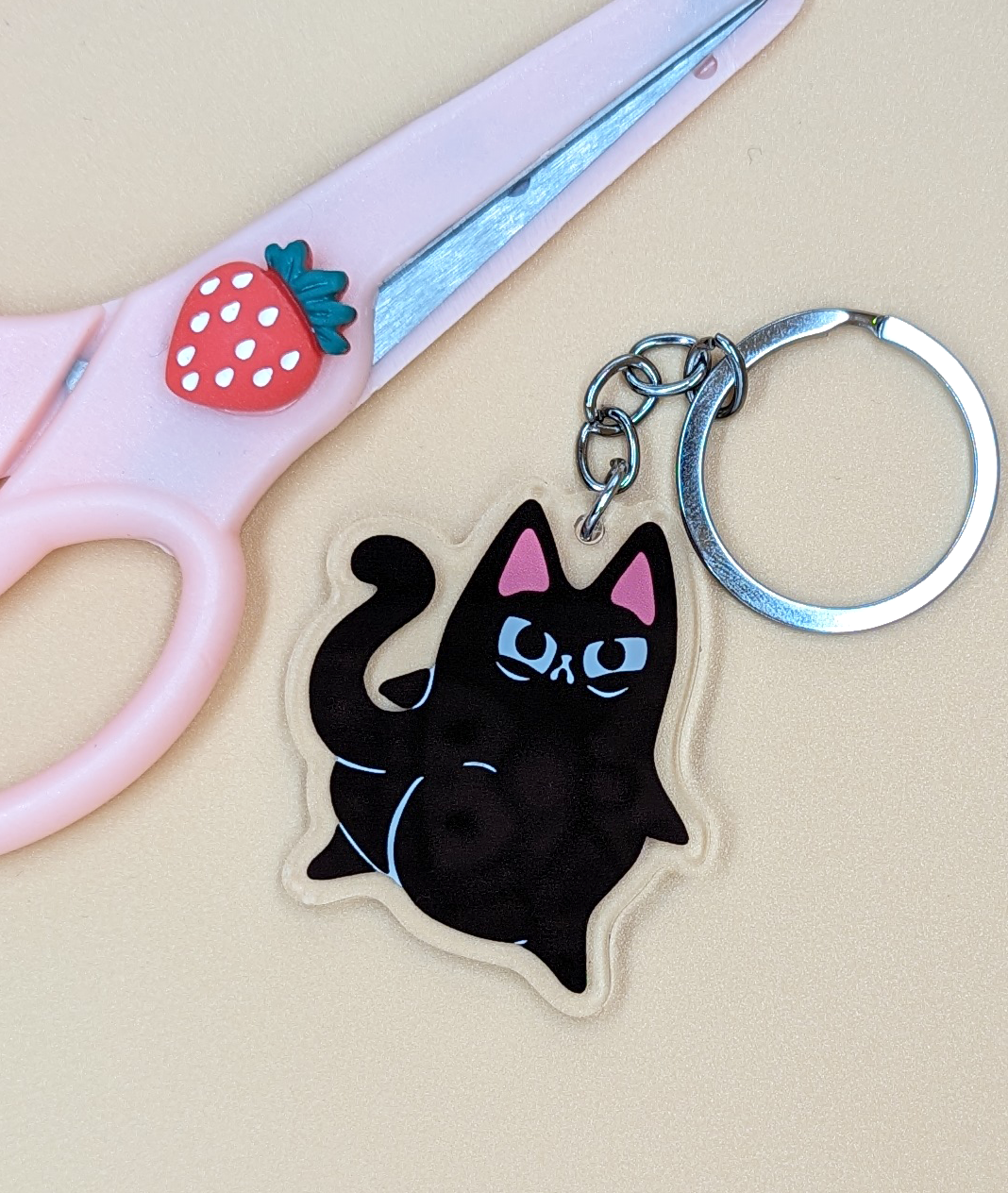 Caked Up Kitty Judgy Cat Acrylic Keychain shows black cat with big booty