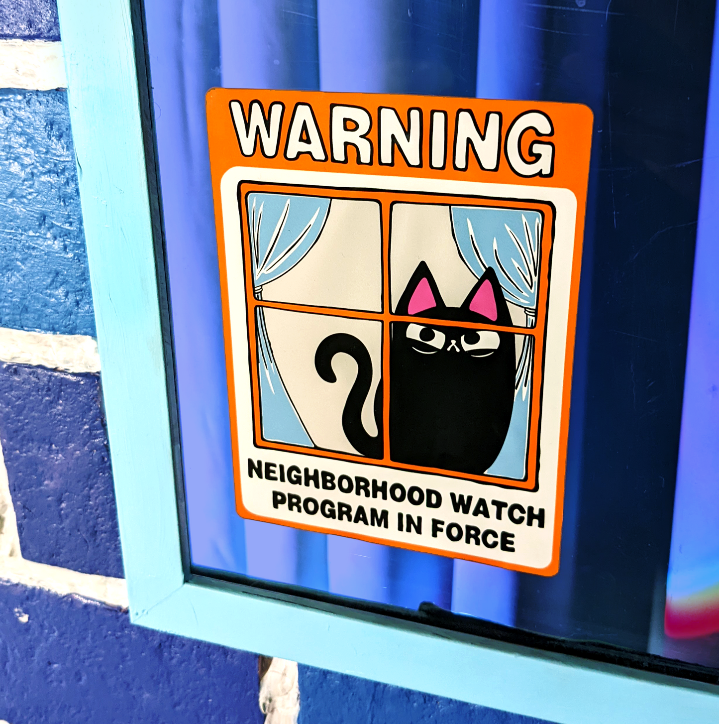 Neighborhood Watch Cat window cling with judgy black cat displayed on window. Original art by BluVelvetArt