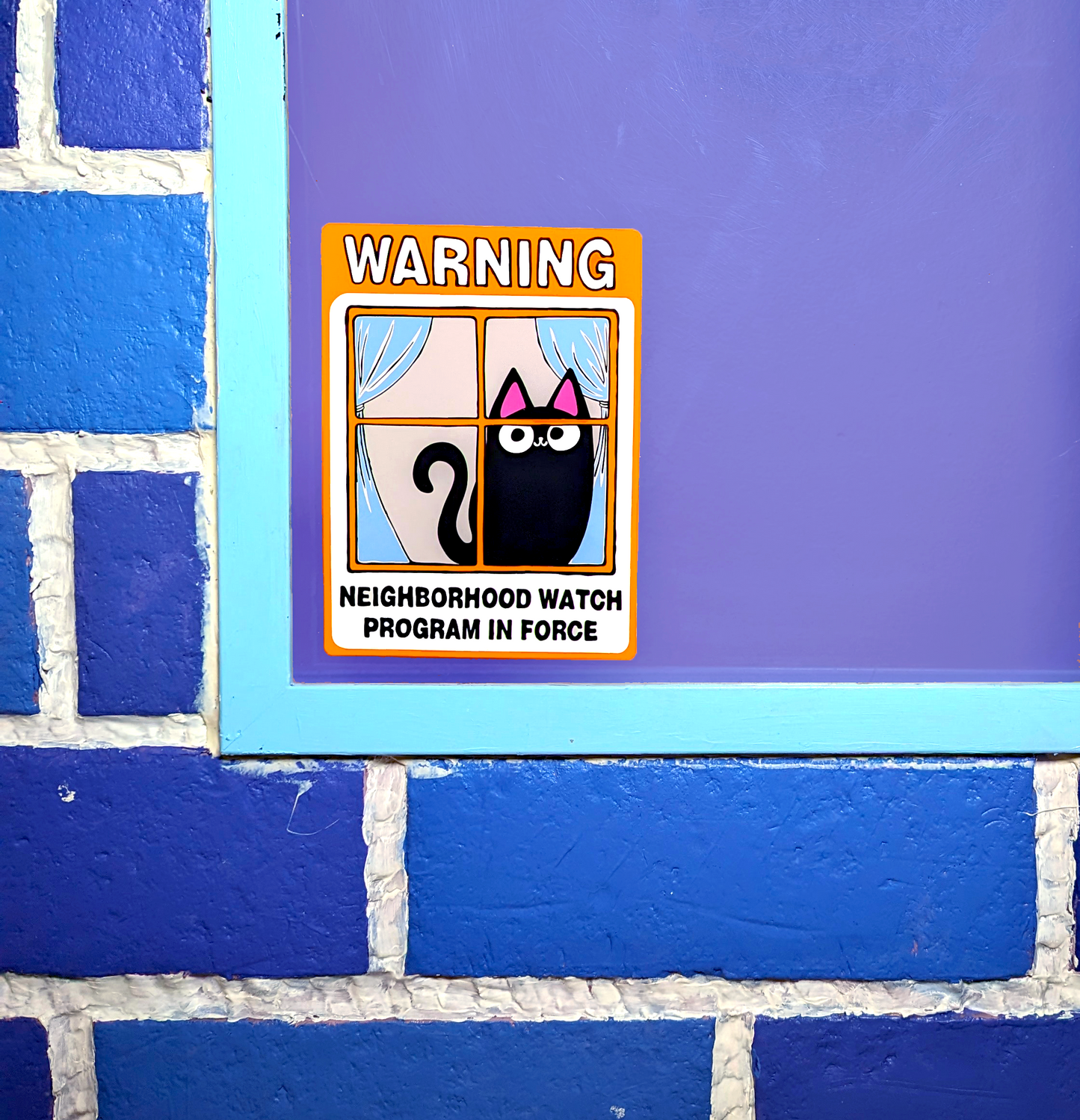 Neighborhood Watch Cat window cling with cute black cat displayed on window