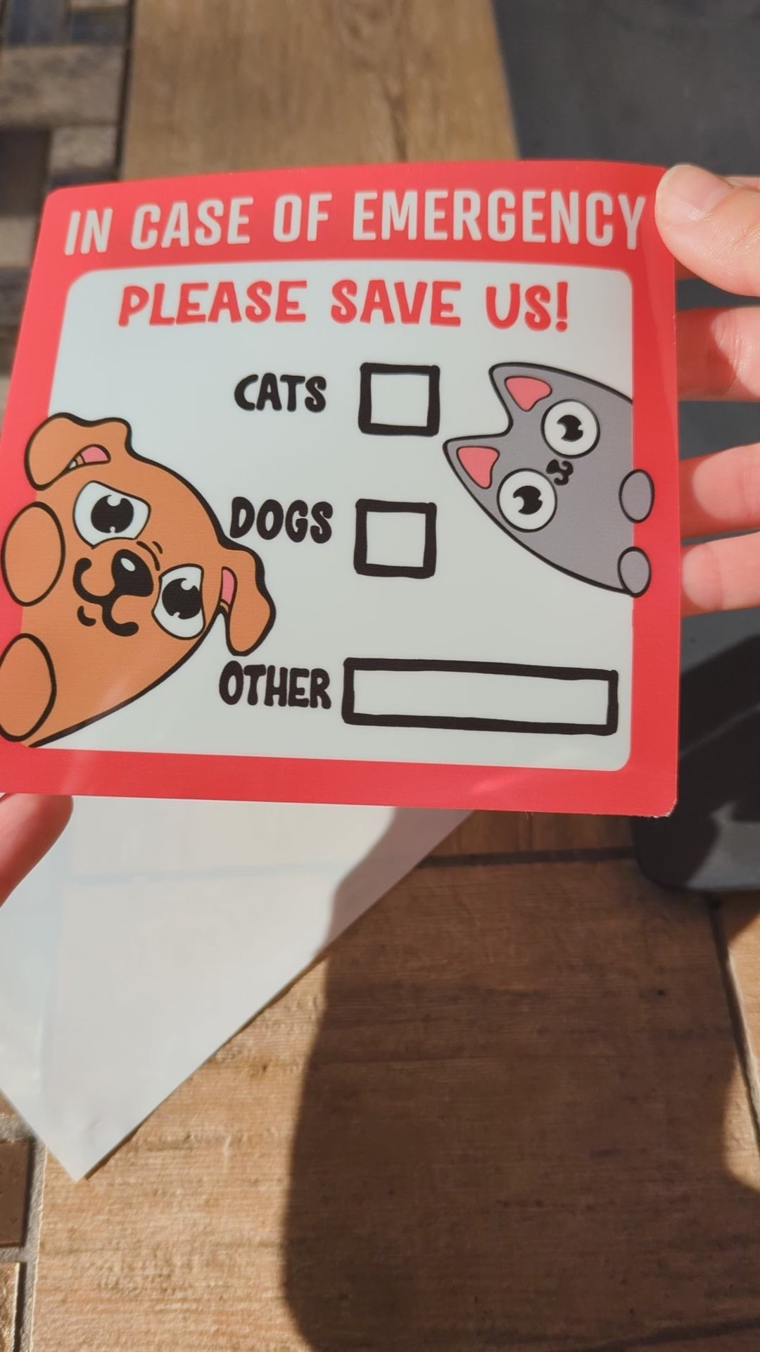 showcase of in case of emergency please save us window cling featuring a cute brown dog and cute grey cat. 